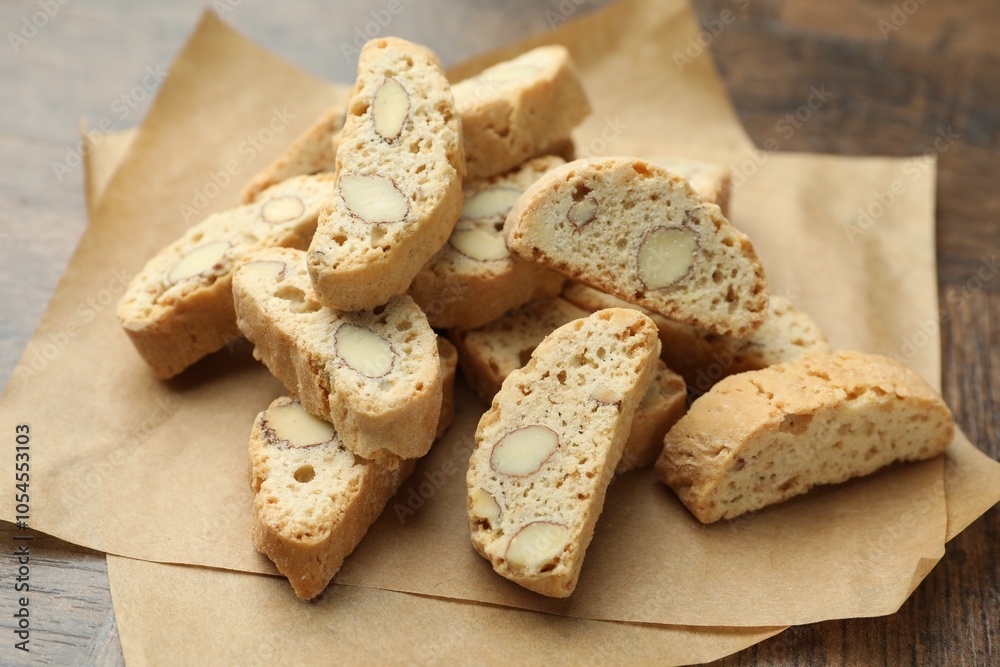 Traditional Italian almond biscuits (Cantucci) and nuts on wooden table, closeup Traditional Italian almond biscuits (Cantucci) and nuts on wooden table, closeup