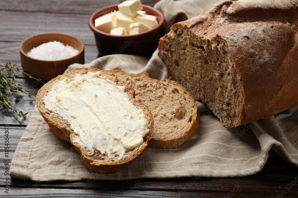 Fresh bread with butter on wooden table, closeup Fresh bread with butter on wooden table, closeup