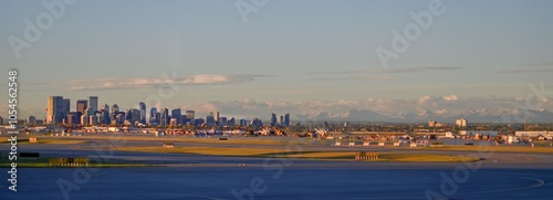 Calgary skyline at sunrise with rocky mountains in the background, panoramic landscape shot from the airport