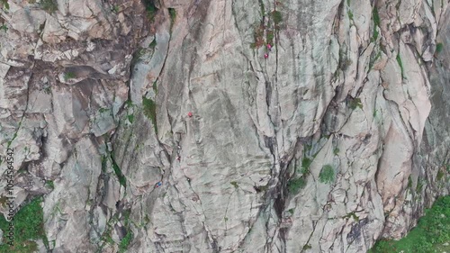 Climbers ascending steep rock face in the mountains
