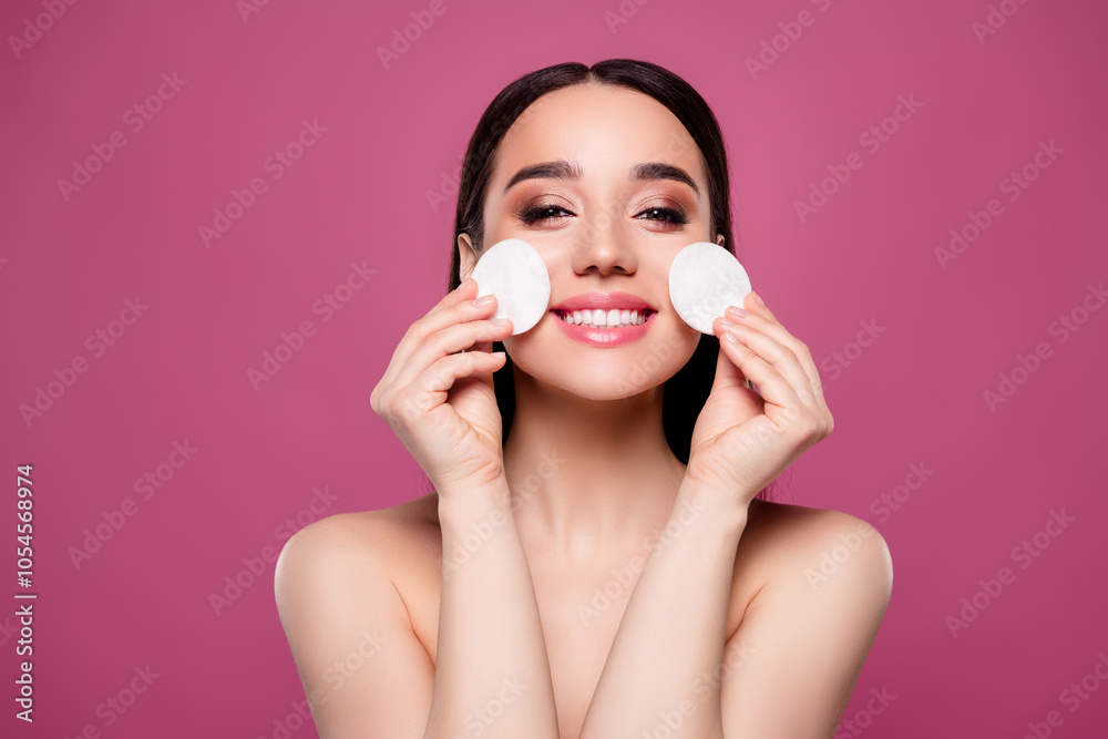 Photo of joyful girl use cotton pad tender skin remove make up on pink color background Photo of joyful girl use cotton pad tender skin remove make up on pink color background