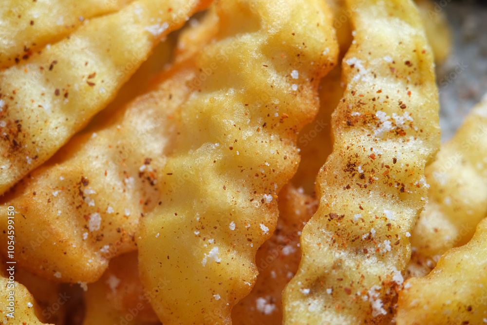 Close up of crinkle fries with paprika powder and salt Close up of crinkle fries with paprika powder and salt