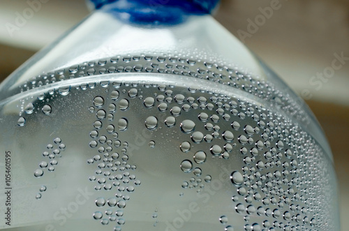 beautiful water bubbles in a plastic mineral water bottle. extreme close up of water container with blurred background