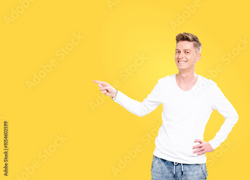 Man in a white shirt pointing to the right. He is smiling. The background is yellow