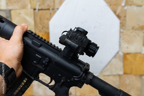 American rifle with thermal imaging sight at a shooting range, close-up photo.