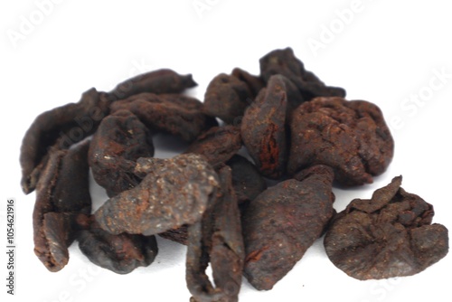 The photo shows a close-up of dried Garcinia xanthochymus (asam kandis) peels. These peels are commonly used in Southeast Asian cuisine, particularly in Indonesian cooking. photo