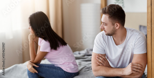 Unhappy Marriage. Husband And Wife After Quarrel Sitting On Different Sides Of Bed At Home. Selective Focus