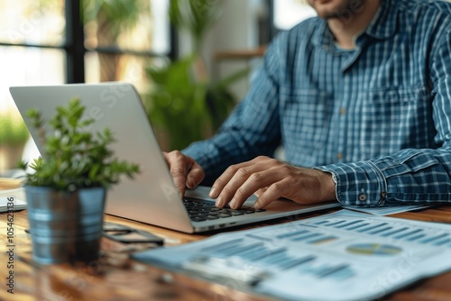 Businessman Working on Financial Analysis with Laptop in Modern Office