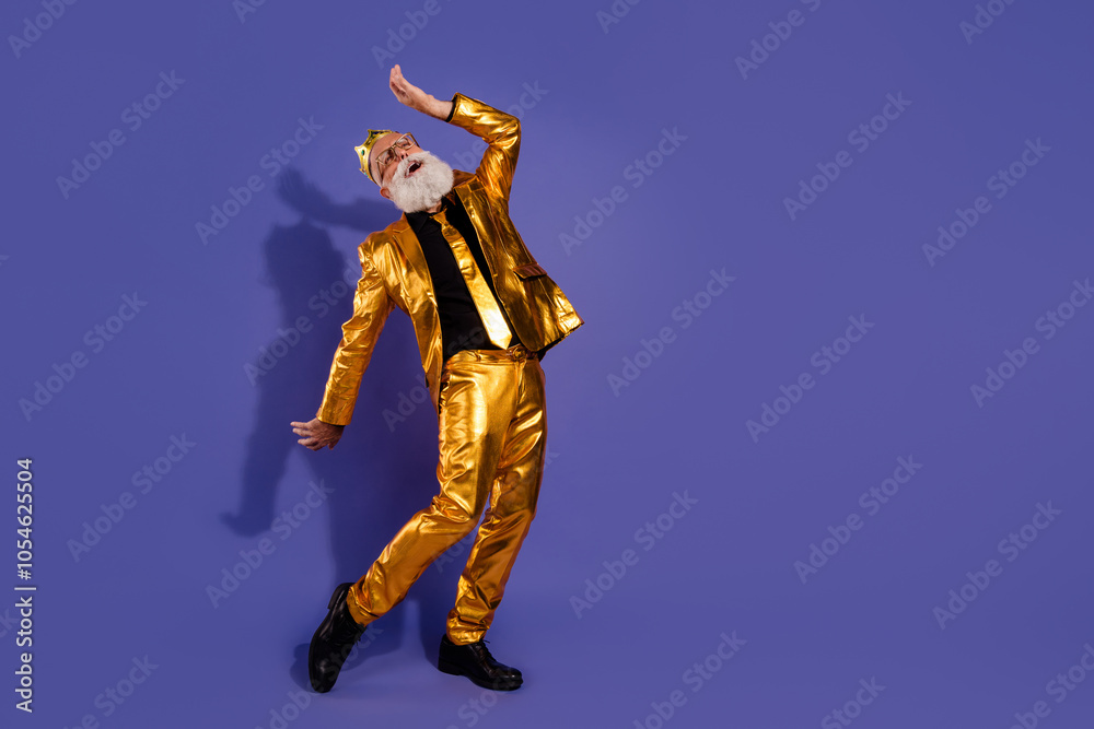 Full body photo of bearded gentleman dancing have fun wear fashionable golden clothes isolated on violet color background Full body photo of bearded gentleman dancing have fun wear fashionable golden clothes isolated on violet color background