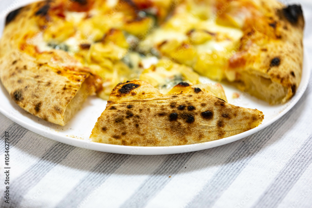 Traditional rustic pizza made with four cheeses, garlic and oil and pear with gorgonzola