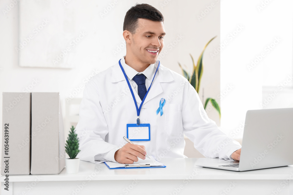 Male urologist with blue ribbon working in clinic. Prostate cancer awareness concept Male urologist with blue ribbon working in clinic. Prostate cancer awareness concept