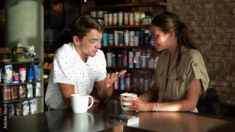 Happy couple in a cafe enjoying their coffee. Man and woman drinking coffee. happy couple having a nice conversation over a cup of coffee in a cozy cafe Happy couple in a cafe enjoying their coffee. Man and woman drinking coffee. happy couple having a nice conversation over a cup of coffee in a cozy cafe
