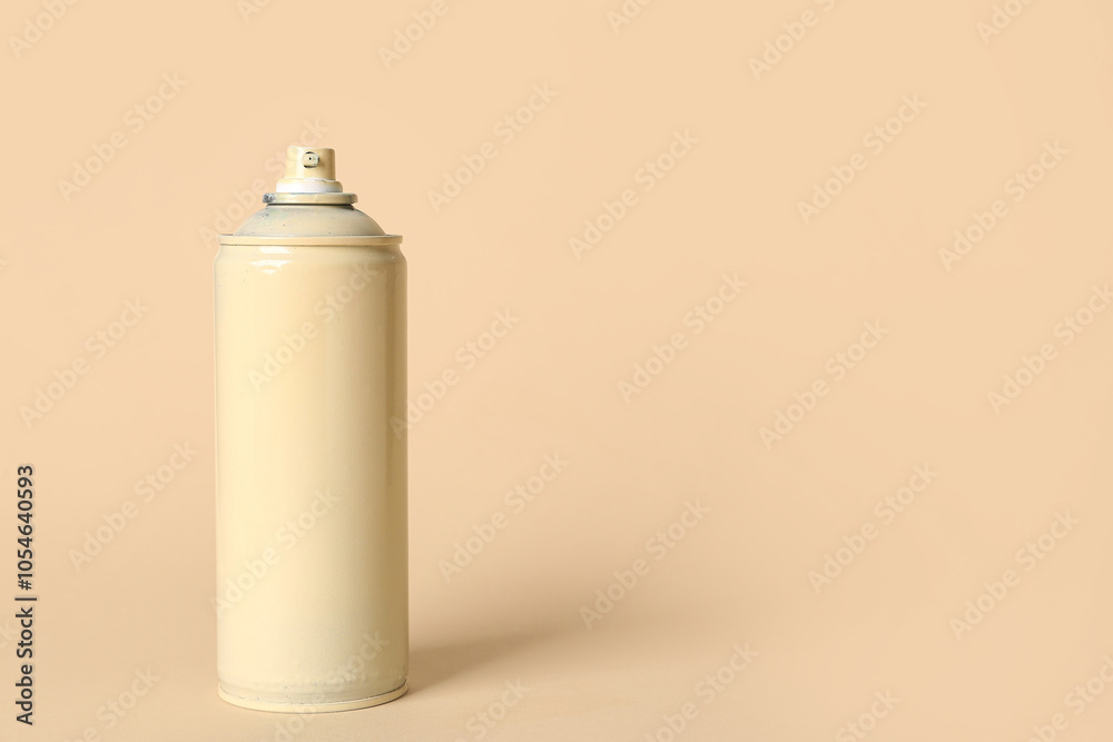 Spray paint can on beige background Spray paint can on beige background