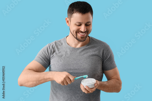 Young man with tooth powder...