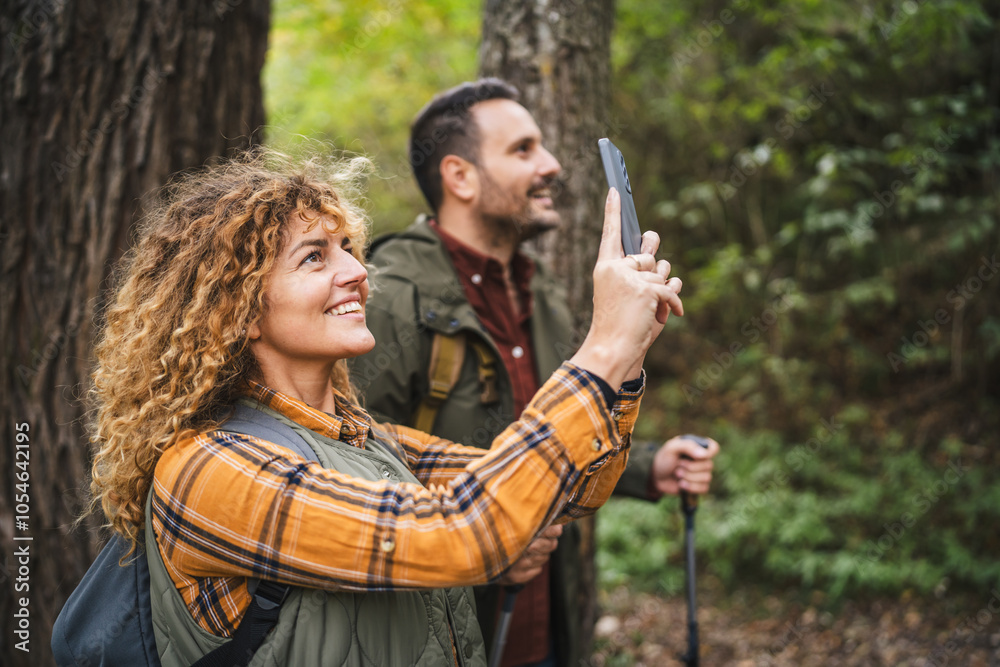 side view of hiker couple husband and wife take photo of nature side view of hiker couple husband and wife take photo of nature