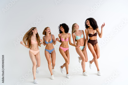 Full body photo no filter of young girls posing body positive run hold hands wear colorful lingerie natural day light studio background