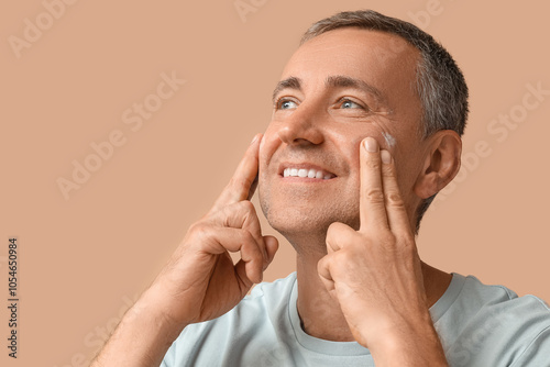 Happy mature man applying c...