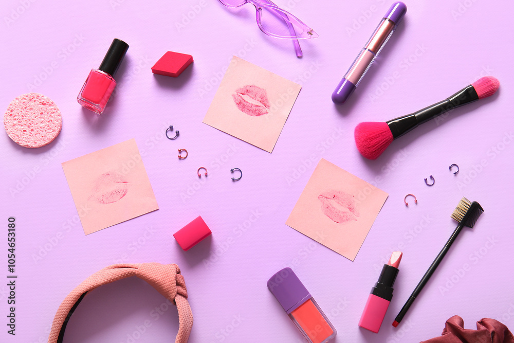 Composition with decorative cosmetics, accessories and lipstick kiss marks on lilac background Composition with decorative cosmetics, accessories and lipstick kiss marks on lilac background