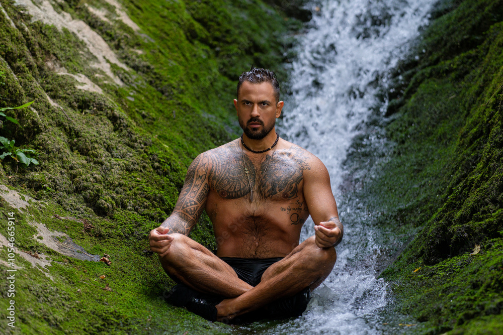 Meditation and wellness in nature. Man Freedom in environment. Relaxed man meditating against waterfall at forest in nature. Freedom and carefree lifestyle. Travel and tourism in nature concept. Meditation and wellness in nature. Man Freedom in environment. Relaxed man meditating against waterfall at forest in nature. Freedom and carefree lifestyle. Travel and tourism in nature concept.