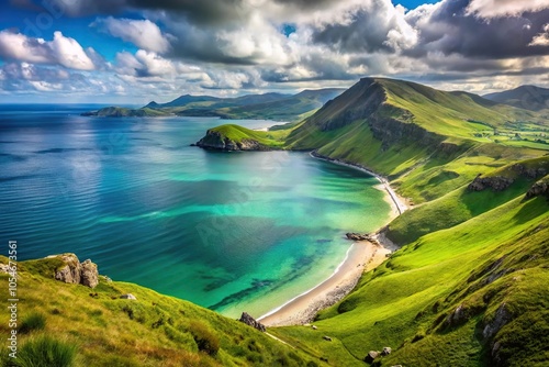 Scenic coastline with mountains, grassy slope, and emerald water from a high angle view.