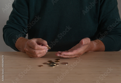 A man at the table counting coins