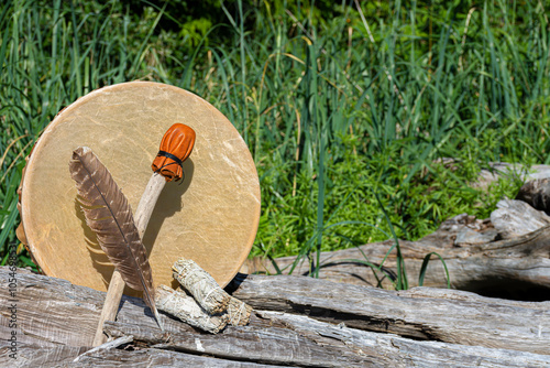 Handmade leather meditation drum with sacred feather and rattle.  photo