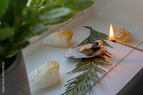 A close up image of a wooden incense stick being lit by a wooden match. photo