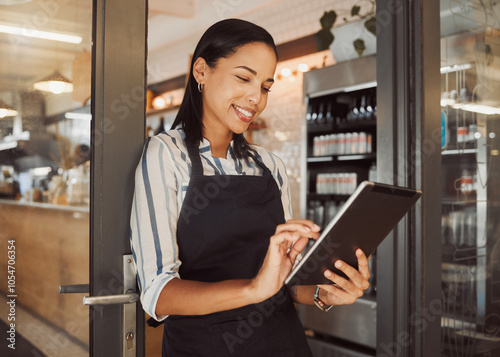 Woman, business owner and tablet by entrance of cafe for ecommerce website, inventory delivery and supply chain. Smile, female waitress and digital for online order, hospitality reviews and checklist photo