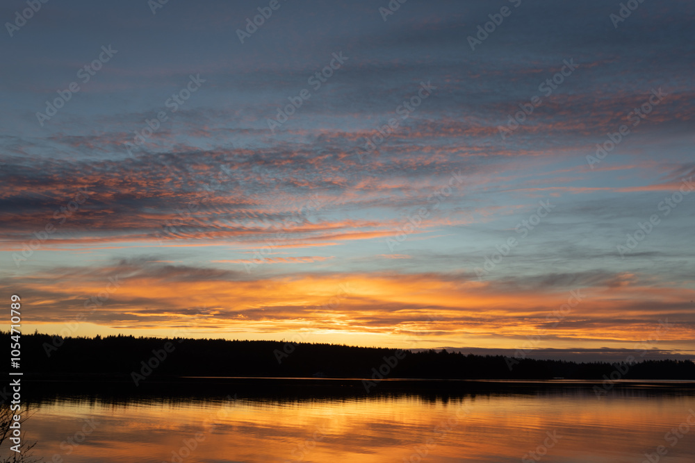 Glowing orange sunrise reflecting on the ocean Glowing orange sunrise reflecting on the ocean
