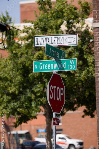 Tulsa, Oklahoma, USA - June 25, 2023: Afternoon sun shines on a sign of the historic Greenwood District Black Wall Street, site of the 1921 Tulsa Race Massacre.