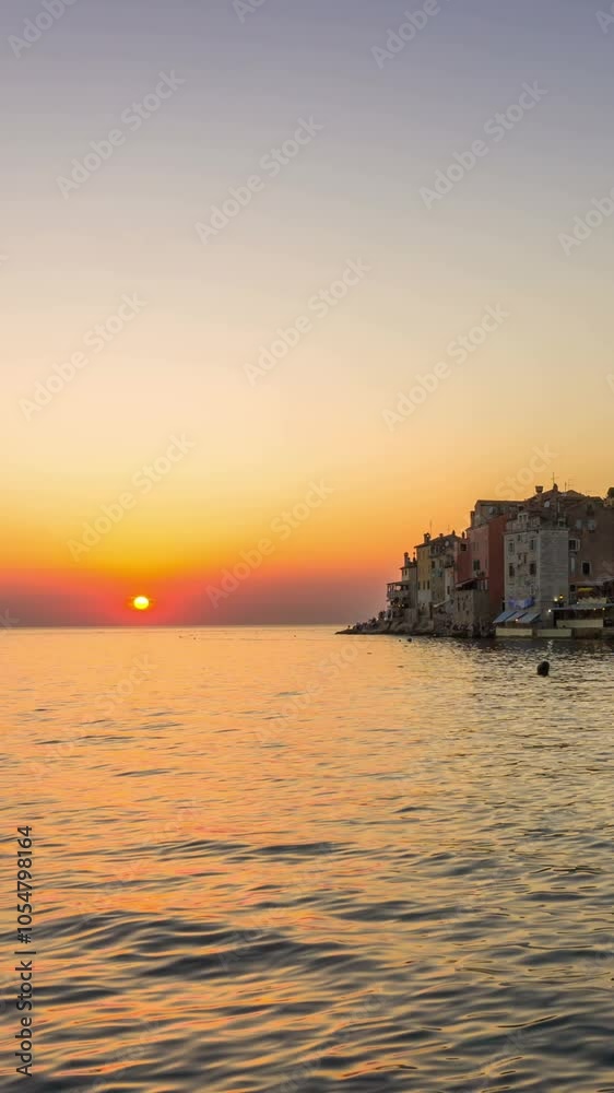 Sunset time lapse at Rovinj, Croatia - Panoramic view of old town of Rovinj in Istria, Croatia at beautiful colorful sunset sky. Rovinj is popular tourist resort, fishing port and culture of Croatia. Sunset time lapse at Rovinj, Croatia - Panoramic view of old town of Rovinj in Istria, Croatia at beautiful colorful sunset sky. Rovinj is popular tourist resort, fishing port and culture of Croatia.