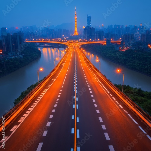 A vibrant cityscape at dusk featuring a highway and illuminated tower.