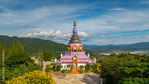 Aerial view of a colourful pagoda overlooking a green valley. pagoda at Wat Thaton on the banks of the Kok River in Chiang Mai Province near the border with Burma..fantastic pagoda of the tribal photo