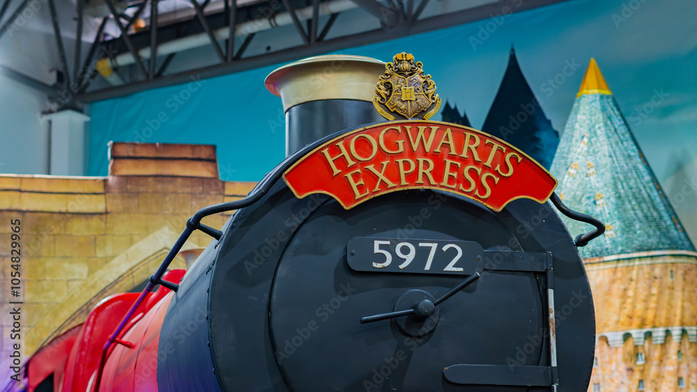 Obraz premium 8th Comic Con Convention In GUAYAQUIL, ECUADOR - AUG 06, 2023 - Iconic Hogwarts Express train with steam, displaying the famous crest and sign, perfect for fantasy and magic themes.