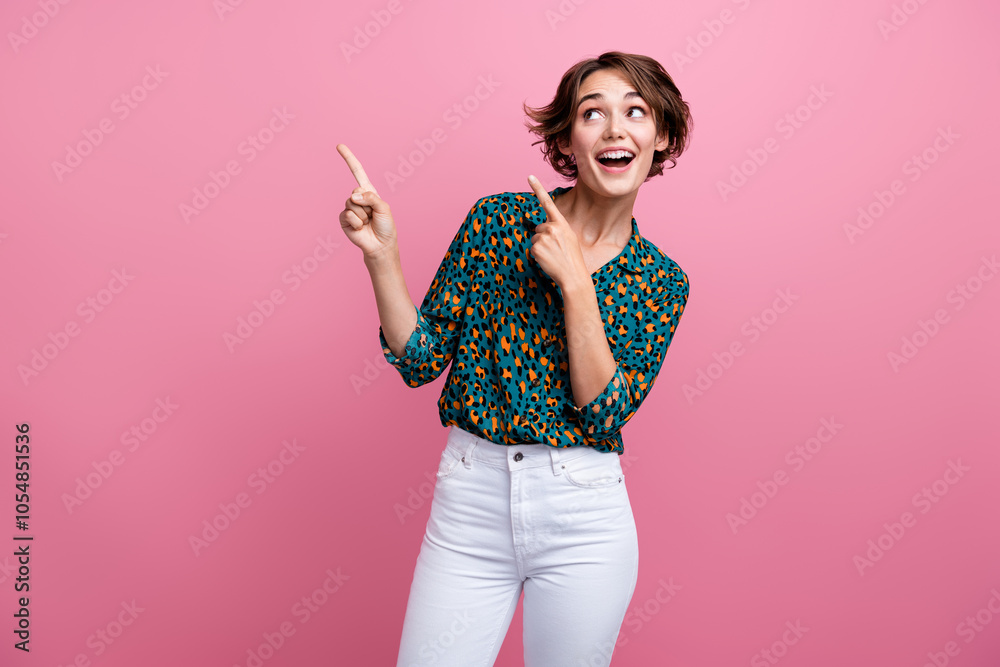 Photo of astonished girl with bob hair dressed print shirt directing look at impressive sale empty space isolated on pink color background Photo of astonished girl with bob hair dressed print shirt directing look at impressive sale empty space isolated on pink color background