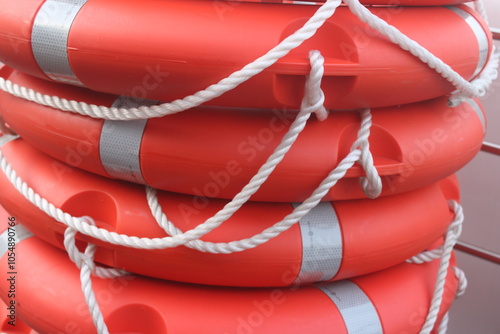 red life buoys stacked on boat deck