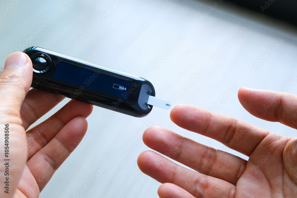 Fototapeta premium man's hands checking diabetes and hyperglycemia with digital blood sugar meter. Healthcare and medical concept 