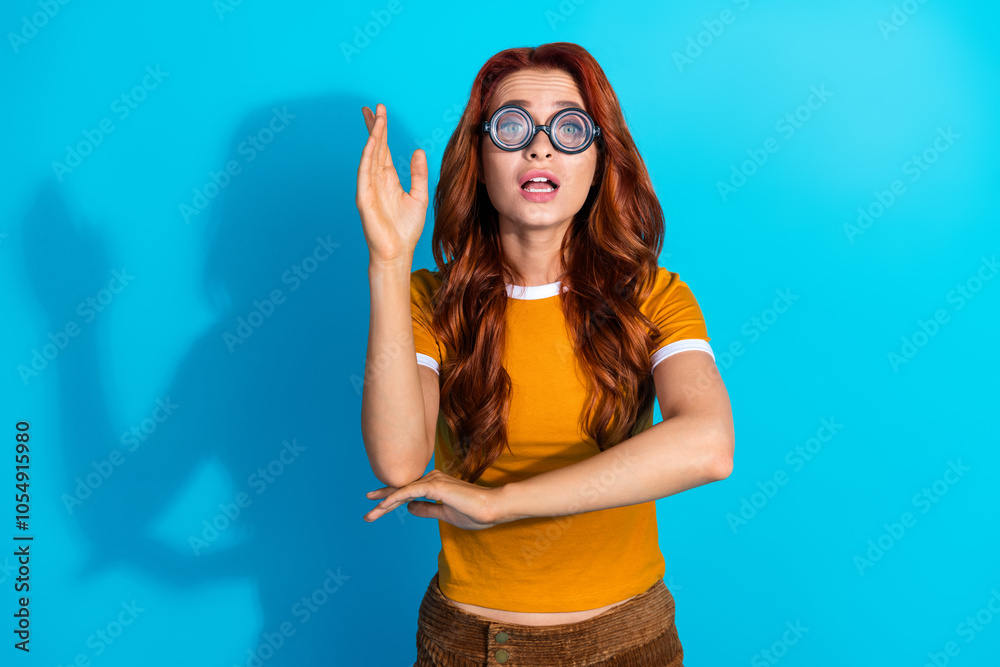 Photo of charming cute clever woman wear trendy clothes showing hand answer isolated on blue color background Photo of charming cute clever woman wear trendy clothes showing hand answer isolated on blue color background
