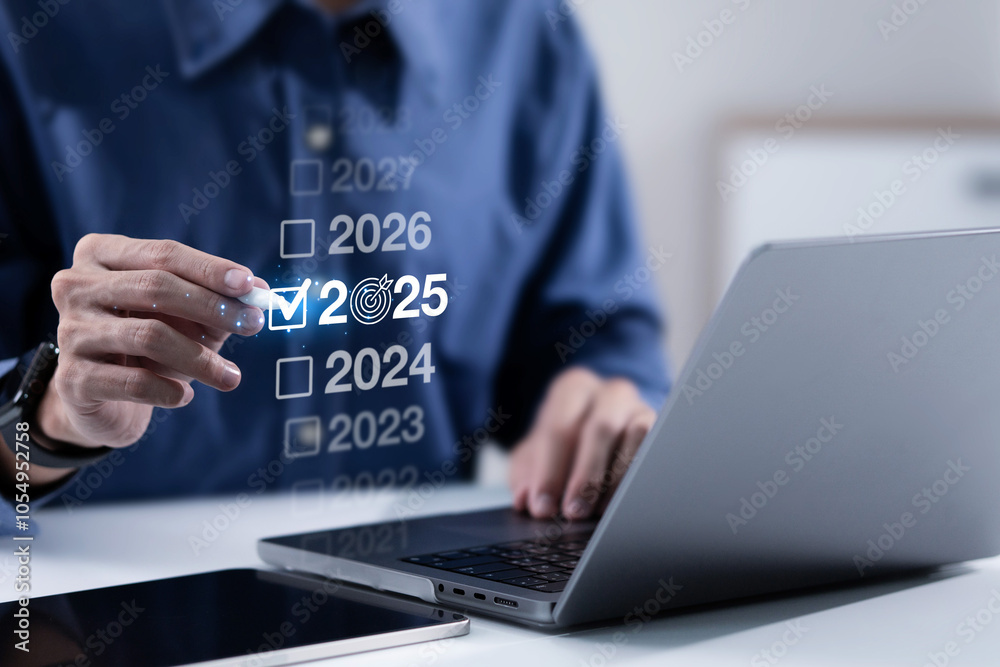 Businessman pointing on 2025. New Year Goals Action Plan. Business plan, finance, ai, future, teamwork, achieving goal. Concept of preparing for new year changes and start strategy idea. Businessman pointing on 2025. New Year Goals Action Plan. Business plan, finance, ai, future, teamwork, achieving goal. Concept of preparing for new year changes and start strategy idea.