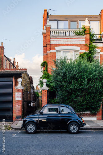 Classic black car parked in front of london house