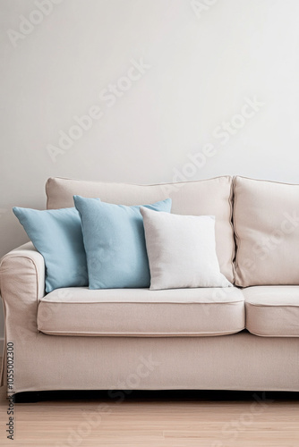 Cozy living room with a light beige couch and decorative pillows arranged for a relaxed atmosphere