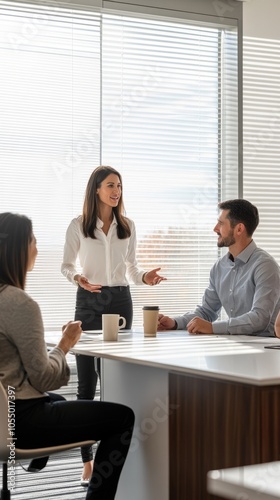 A woman is giving a presentation to two men in a conference room