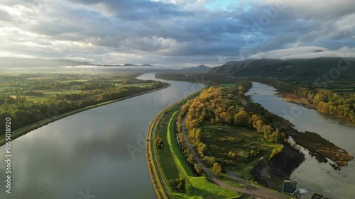 Morning fog over the Rhône River in southern France above the dam and river pollution treatment system – autumn landscape in the glow of the rising sun, overlooking the river bend. photo