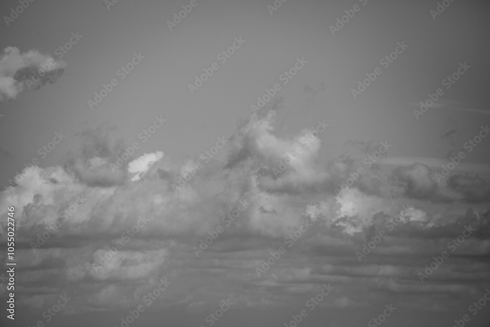 A cloudy sky with a few clouds in the distance A cloudy sky with a few clouds in the distance