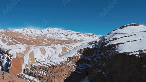 Snow covered mountains during sunny winter day as seen from Chicham Bridge in Spiti Valley, India. Spiti valley landscape. Himalaya mountains covered with snow during sunny day. photo