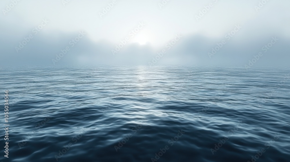 Calm ocean surface reflecting soft light under a cloudy sky during early morning or late evening hours Calm ocean surface reflecting soft light under a cloudy sky during early morning or late evening hours