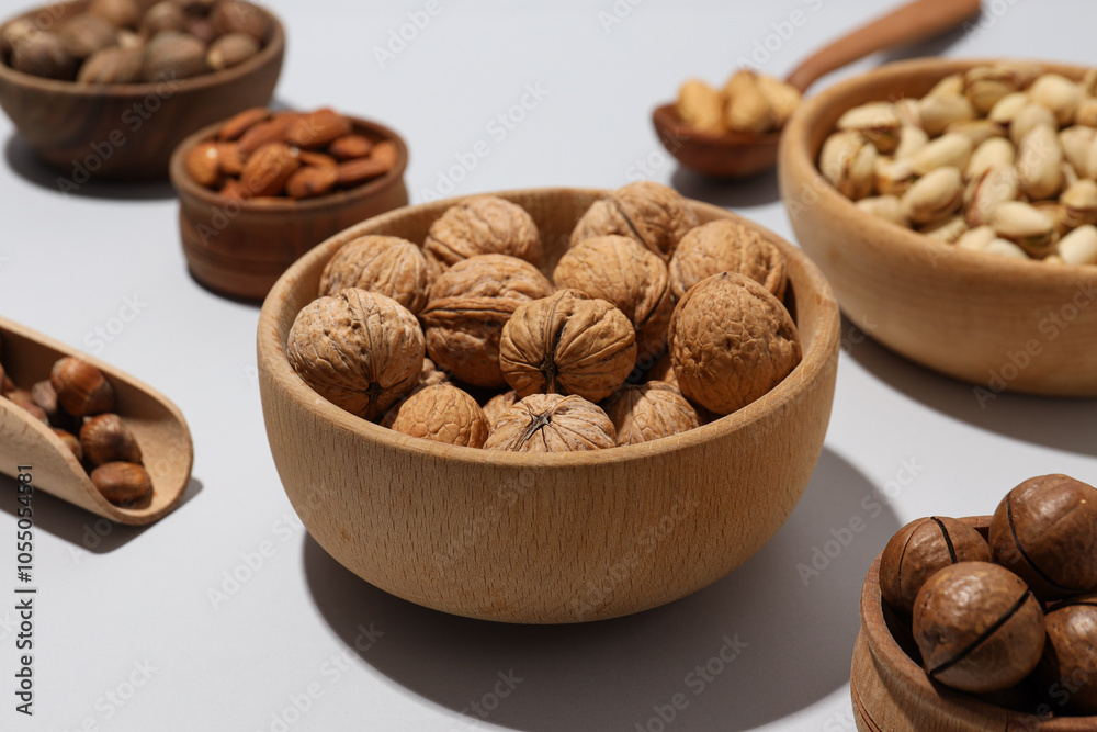 Various nuts in wooden bowls on a gray background Various nuts in wooden bowls on a gray background