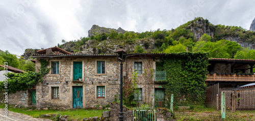 Picturesque houses in the village Cain de Valdeon, at the end of the Cares gorge hiking trail in the Picos de Europa mountains in Asturias, Spain photo