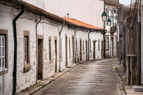 Picturesque narrow alley Rua Roque Barros with small old residential houses in the town center of Viana do Castelo