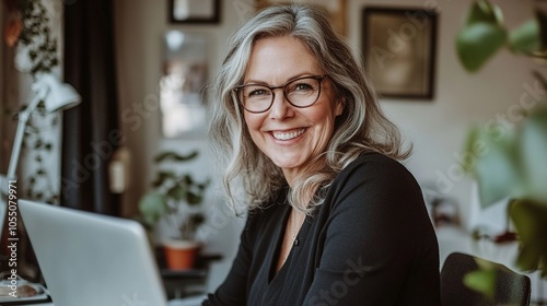 Smiling Woman with Laptop in Cozy Workspace